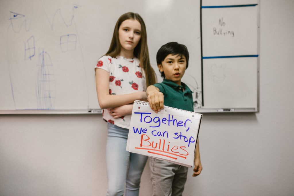 two students showing a message against bullying